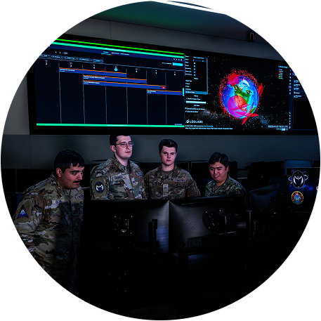 Four Space Force Guardians surrounding a computer
